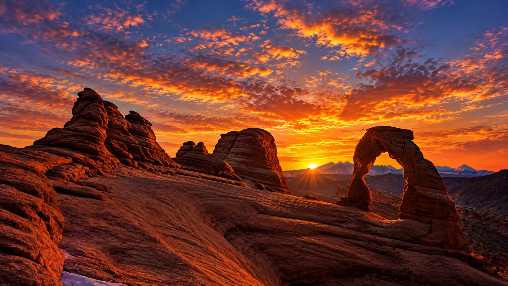 Delicate Arch set against a fiery sunrise in Utah.
